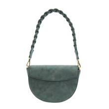 Load image into Gallery viewer, The Luna Crescent Crossbody with Braided Handle is a chic half-moon handbag crafted from teal vegan suede leather, showcasing a braided shoulder strap secured with gold hardware. It features a flap closure and smooth finish for an elegant and modern appearance.
