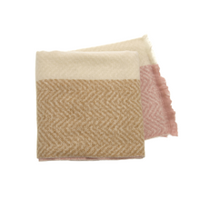 Load image into Gallery viewer, The Cozy Scarves feature a folded design with a chevron pattern that highlights soft textures in three color sections: cream, tan, and dusty pink. Each section presents the chevron design in complementary tones, and subtle fringe detailing adorns one edge. This warm accessory is ideal for cooler weather.
