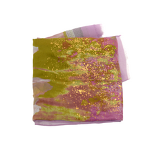 Load image into Gallery viewer, A folded Lightweight Patterned Scarf features an abstract splash design that blends green, yellow, and pink hues. Specks of gold are scattered throughout the fabric, creating a shimmering effect. The scarf is made from lightweight material with soft textures and fringed edges, evoking a paradise-like feel.
