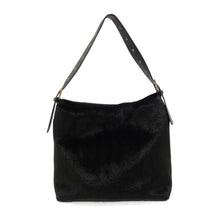 Load image into Gallery viewer, The Teresa Faux Fur Hobo, a chic and sophisticated black faux fur handbag, is displayed. It boasts a smooth texture and features a wide, adjustable black leather shoulder strap adorned with metal studs. Its simple rectangular shape is elegantly highlighted against the plain white background, perfectly showcasing the vegan leather bag.
