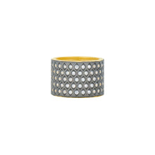 Load image into Gallery viewer, The New Icon Cigar Band features a wide, cylindrical metal ring decoratively embellished with a diamond pattern of small, clear cubic zirconia stones. The interior displays a golden hue, contrasting with the darker, textured metallic finish on the exterior. This striking pavé ring is showcased against a plain white background.
