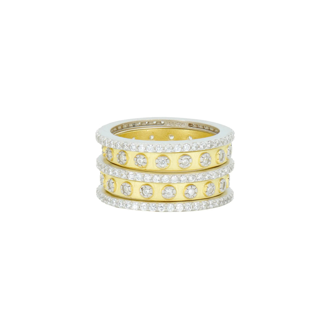 Introducing the Two Tone 5-Stack Ring, a breathtaking creation featuring three stacked bands—two in sterling silver and one gleaming in 14K gold. Each band is beautifully embellished with cubic zirconia stones, offering intricate detailing that transforms this polished piece into a true statement accessory.