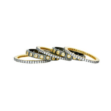 Load image into Gallery viewer, The Two Tone 5-Stack Ring set features a collection of five exquisite stacking rings crafted from 14K gold. Each ring boasts a slim band and is adorned with small diamonds, with some designs highlighting larger diamond accents. Arranged in a diagonal stack, they beautifully showcase their intricate and shimmering details.
