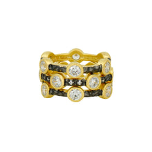 Load image into Gallery viewer, The Starry Night Ring Set is a trio of gold rings embellished with round, clear gemstones encased in bezels, complemented by bands of round, black gemstones that add contrast. The front view accentuates their detailed design and alternating arrangement of gemstones.
