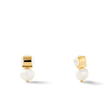 Load image into Gallery viewer, Smooth + Classic Pebble Pearl Post Earrings on a white background. These earrings feature a glossy pearl situated below a sleek 14 karat gold square accent, designed in a minimalist and elegant style. They include hypoallergenic backing for added comfort, with visible shadows beneath them.
