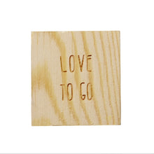 Load image into Gallery viewer, Porcelain Gift in Wood Box, featuring a square wooden plaque engraved in uppercase with &quot;LOVE TO GO.&quot; Elegantly crafted to fit perfectly inside the box, its light natural finish highlights visible grain patterns while the centered engraving appears against a plain white background.
