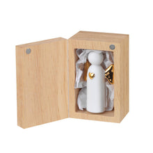 Load image into Gallery viewer, Inside the open wood box, lined with crumpled white tissue paper and featuring a magnetic closure, stands the Porcelain Gift in Wood Box. This small white porcelain figure is adorned with a golden heart accent, presented upright as the box is angled to reveal its exquisite interior—a perfect gift.
