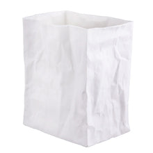 Load image into Gallery viewer, Upright on a plain white background, a handcrafted &quot;Paper Bag&quot; Vase made of white porcelain replicates the textured, uneven look of slightly crumpled paper. The vase features a rectangular, open top and stands empty.
