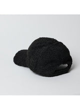 Load image into Gallery viewer, The Sherpa Cap, with its fuzzy black texture and soft surface, is displayed against a plain white background. Ideal for fall and winter fashion, it is shown from the back, showcasing its curved brim and adjustable opening at the base.
