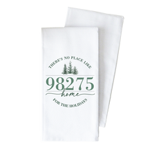 Load image into Gallery viewer, As part of our custom-designed kitchen collection, the Summit Tea Towel in white showcases the phrase &quot;THERE&#39;S NO PLACE LIKE 98275 HOME FOR THE HOLIDAYS&quot; elegantly printed in green. Above the number are three small pine trees, adding a festive accent. The towel is neatly folded to highlight its delightful design.
