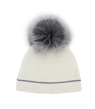 Load image into Gallery viewer, Introducing the Knit Beanie with Crystal Contrast Line and Fox Fur Pom-Pom: a cozy white knitted beanie featuring a playful and fluffy gray fox fur pom-pom on top. It has a ribbed texture complemented by a decorative dark gray stripe near the bottom edge, making it a stylish classic winter accessory.
