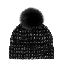 Load image into Gallery viewer, Introducing the Knit Crystal Beanie with Fox Fur Pom-Pom: a chic black beanie embellished with glittering rhinestones arranged in a grid pattern and topped with a large, fluffy fox fur pom-pom. The folded brim adds both texture and warmth, making it a stylish and fashionable accessory.
