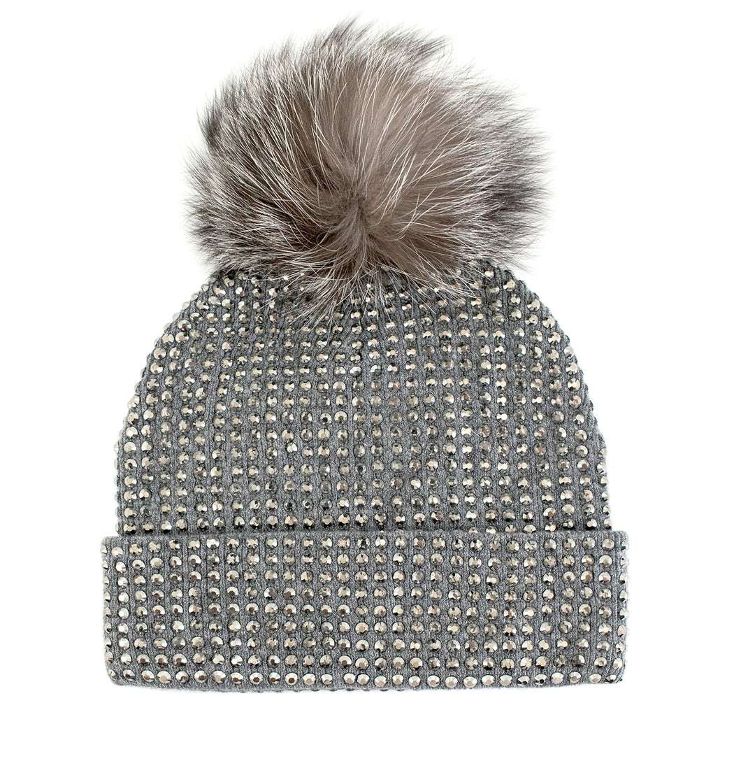 The Knit Crystal Beanie with Fox Fur Pom-Pom comes in a soothing gray hue, sparkling with rhinestones and topped with a large, fluffy faux fur pom-pom. Its fold-over cuff enhances the texture and style of the design, offering both warmth and chic elegance for your winter wardrobe.