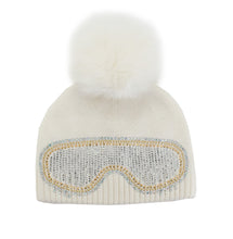 Load image into Gallery viewer, A sophisticated white knit beanie, topped with a luxurious fox fur pom-pom, features an eye-catching ski goggles design on the front, embellished with dazzling silver and gold rhinestones.
