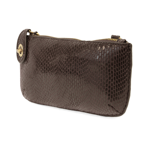 The Mini Crossbody Wristlet Clutch - Fall/Winter features a brown snakeskin pattern with a glossy texture, gold zipper, and decorative gold button. Its elegant design includes removable straps for versatility, allowing it to transition from a clutch to a chic crossbody wristlet.