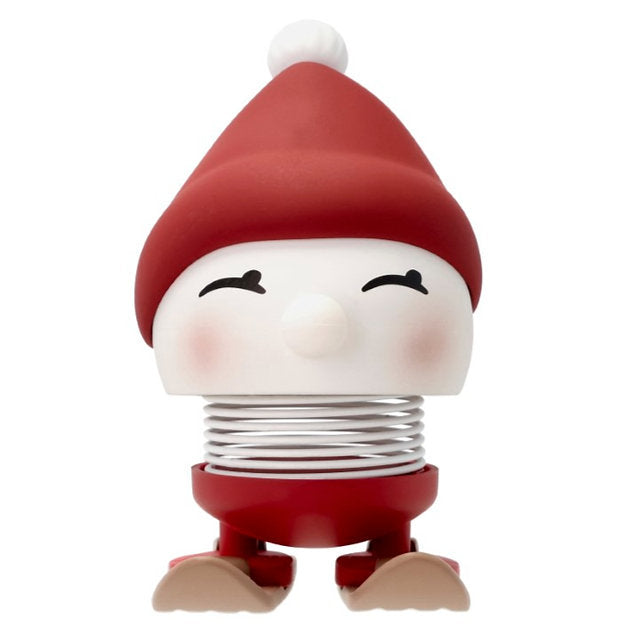 The Hoptimist Skiing Bumble, crafted from durable ABS plastic, features a red hat and boots with charming rosy cheeks on its white face. Its coil spring body creates a playful bouncing effect reminiscent of skiing through a winter landscape.