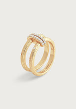 Load image into Gallery viewer, The Enchanted Forest Chain Double Ring features a dual-band design plated with 18K gold, highlighting a textured, bark-like pattern. The top is adorned with small, sparkling diamonds, and the inner band showcases intricate engravings. Set against an off-white backdrop, its elegance subtly radiates like a crystal in the light.
