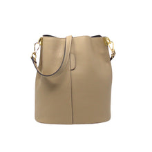 Load image into Gallery viewer, The beige Leather Bucket Bag features Italian leather with a pebbled texture, curved handle, and gold hardware with side clasps. Its slightly open top reveals a dark interior lining, providing a minimalist and elegant design for both casual and formal occasions.
