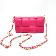 Load image into Gallery viewer, The Leather Quilted Bag, a small pink rectangular handbag made of Italian leather, is shown against a white background. It has a gold chain crossbody strap interwoven with pink leather and a detachable side strap, adding to its stylish and modern quilted texture.
