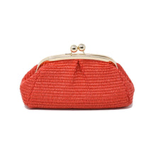 Load image into Gallery viewer, The red woven Raffia Bag clutch features a gold metal clasp with two knobs. Its textured body gives a handcrafted look, similar to a raffia bag, and its rounded shape with a flat base allows it to stand upright, providing elegance and stability.
