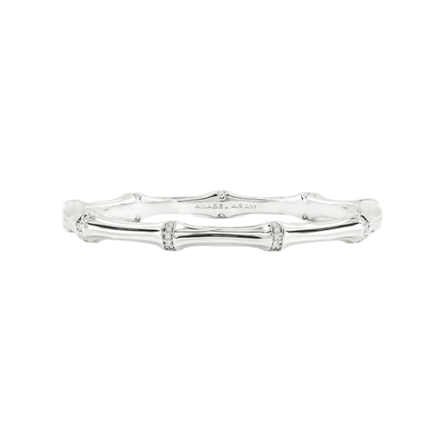 The Bamboo Hinged Bangle - Silver features textured nodes and smooth segments on a soft gray backdrop. Engraved with 