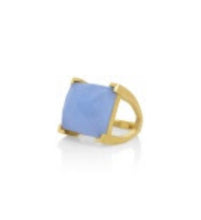 Load image into Gallery viewer, Introducing the Plaza Ring: a captivating gold ring with a large, square-cut blue stone in a prong setting. Its reflective finish on a white surface and soft shadows enhance its elegant simplicity.
