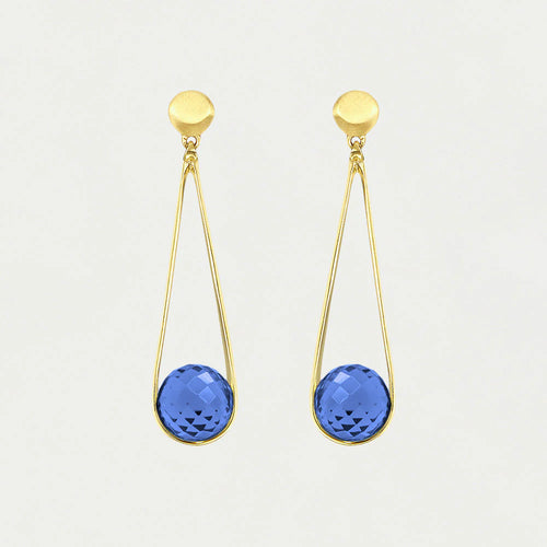 The Mini Ipanema Earrings are stunning gold drop earrings featuring round tops and dangling open teardrop loops, each adorned with an ethically sourced, checkered-cut blue gemstone. Their minimalist design shines effortlessly against a plain white background.