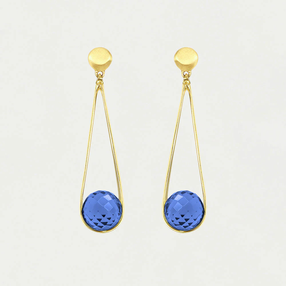 The Mini Ipanema Earrings are stunning gold drop earrings featuring round tops and dangling open teardrop loops, each adorned with an ethically sourced, checkered-cut blue gemstone. Their minimalist design shines effortlessly against a plain white background.