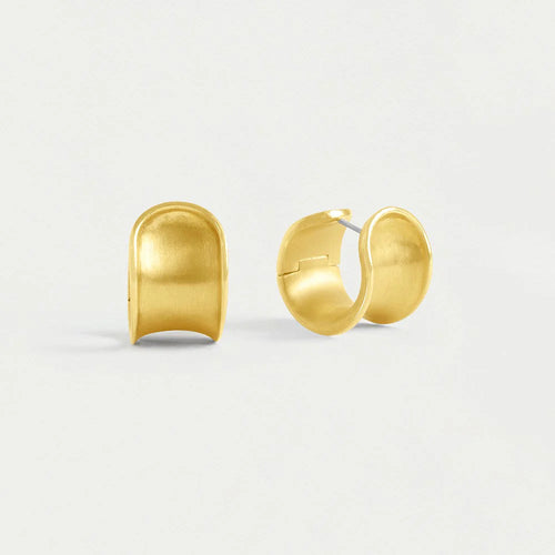 On a plain white background, the Sol Huggie Hoops, crafted in brushed gold-plating, are displayed side by side. Each hypoallergenic earring features a smooth, slightly curved surface with an open back and gleams with a shiny polished finish.