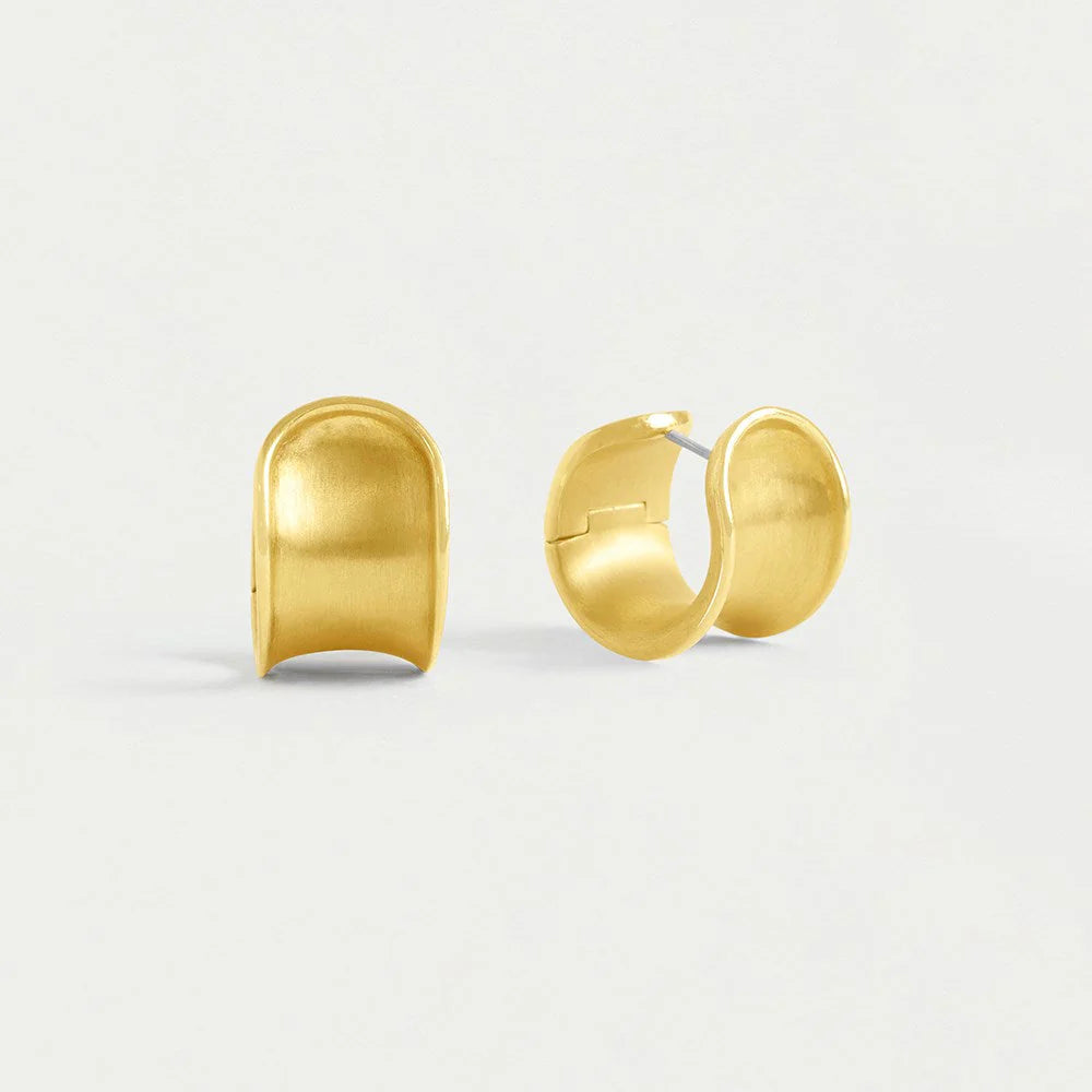 On a plain white background, the Sol Huggie Hoops, crafted in brushed gold-plating, are displayed side by side. Each hypoallergenic earring features a smooth, slightly curved surface with an open back and gleams with a shiny polished finish.