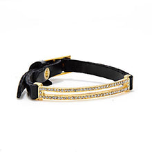 Load image into Gallery viewer, The Skinny Pave Rectangle Leather Bracelet in Gold features a black Italian leather strap with an 18K gold-finish and a gold buckle. Two parallel rows of sparkling rhinestones enhance its elegant, luxurious design, set against a minimalist white background.
