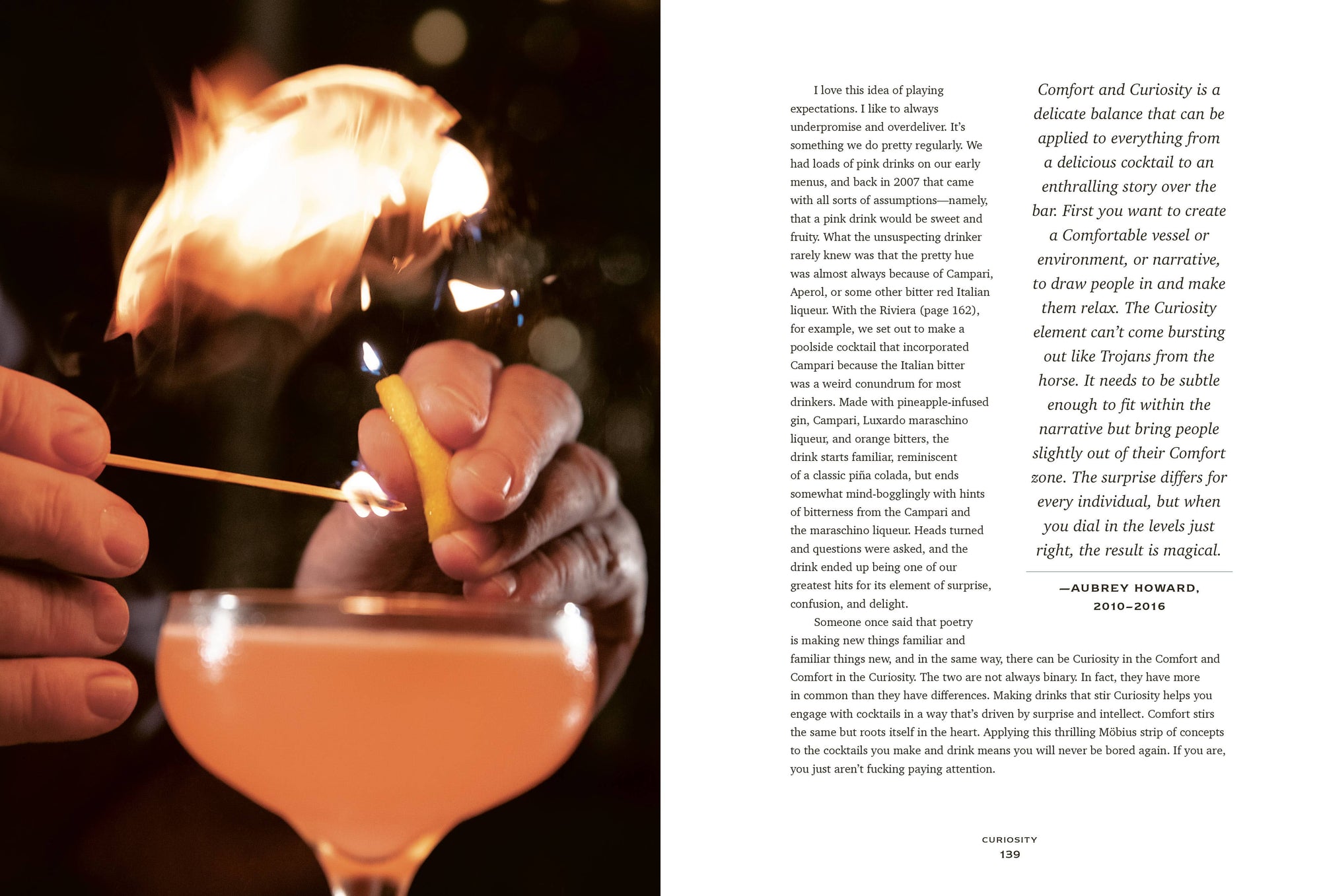 Close-up of hands holding a matchstick, lighting a cigar. In the foreground, a cocktail crafted from "The Bartender's Manifesto" with a frothy top takes center stage. The opposite page delves into text about experiences and curiosity, emphasizing comfort. Soft lighting creates a warm, inviting atmosphere.