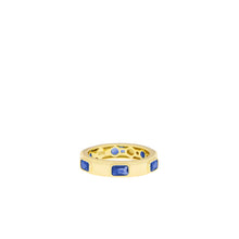 Load image into Gallery viewer, The Gold Plated Spaced Baguette Eternity Ring features rectangular blue stones evenly spaced around its band. The interior is stamped with &quot;925K,&quot; signifying its sterling silver composition, and it has a smooth, polished finish. With its slightly thicker flat design, this statement ring stands out beautifully against a plain white background.
