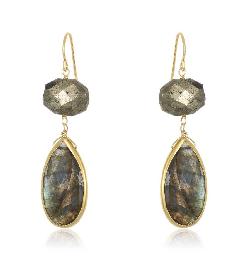 The Alexa Labradorite earrings showcase a sophisticated design with faceted pyrite stones at the top and teardrop-shaped labradorite drops encased in gold frames below. They feature delicate gold-filled ear wires that beautifully accentuate the shimmering gray and blue hues of the stones.