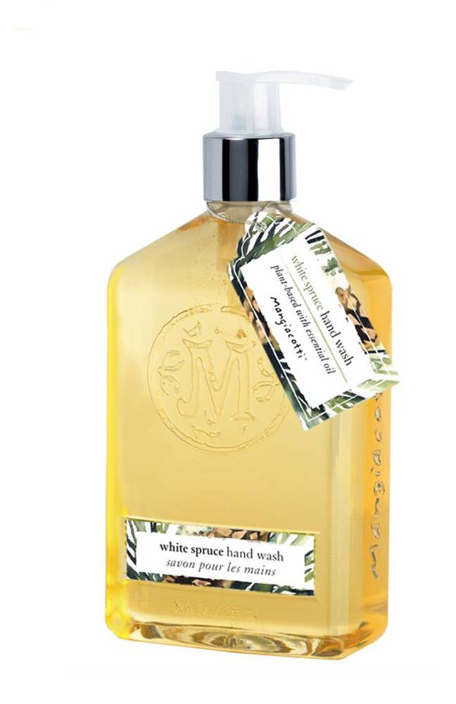 The White Spruce Hand Soap comes in a rectangular bottle featuring a pump dispenser, containing a plant-based, biodegradable formula. The transparent bottle showcases the yellow liquid inside, complemented by a decorative label and hanging tag with a green and white design, displaying the product name in both English and French.