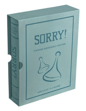 Load image into Gallery viewer, A teal box containing the &quot;Sorry! Vintage Bookshelf Edition&quot; board game, styled to resemble a fabric-wrapped book, showcases an illustration of two game pieces. Text at the bottom highlights that it is a collectible bookshelf edition suitable for ages 6 and up, accommodating 2-4 players.
