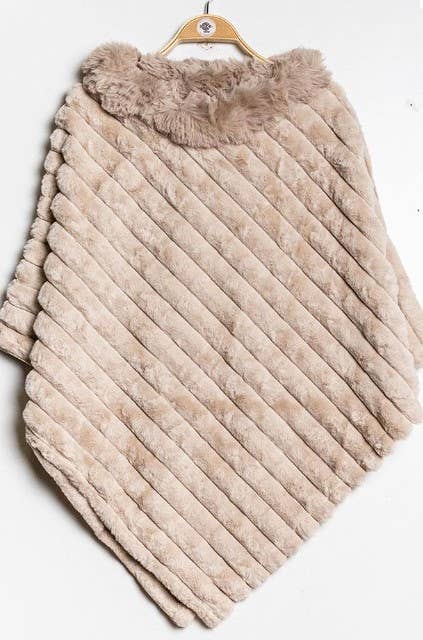 A beige Faux Fur Poncho hangs on a wooden hanger, displaying its diagonal striped pattern and plush, textured collar. This elegant garment offers cozy warmth and is elegantly highlighted against a plain white background, emphasizing its soft texture and stylish shape.