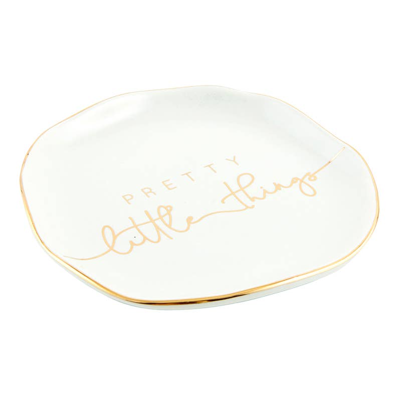 The Trinket Tray - Little Things boasts a slightly wavy edge and metallic gold rim, with "Pretty little things" elegantly inscribed in soft gold cursive at the center, creating a charming ceramic holder for your delicate treasures.