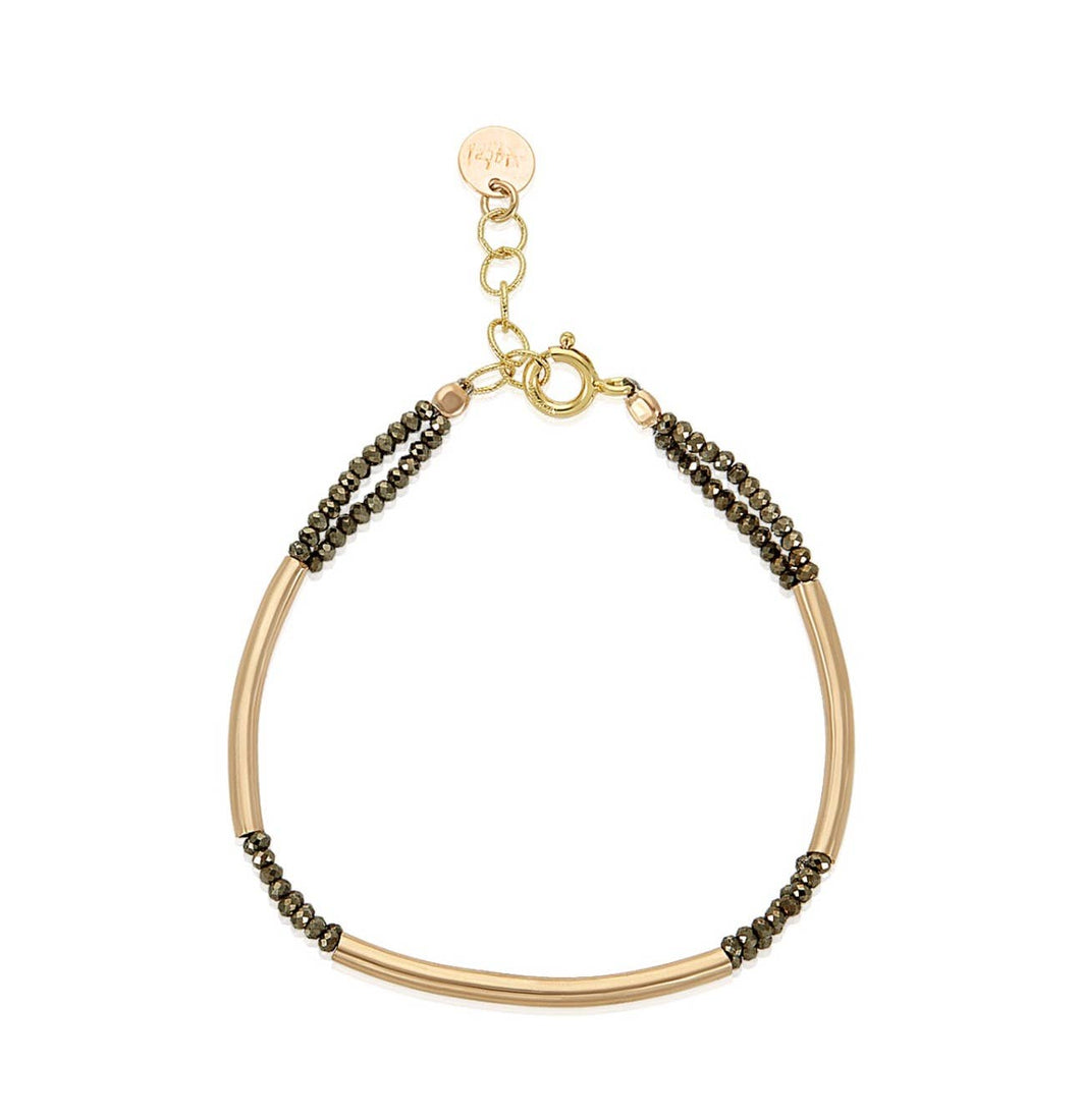 The Tubular Pyrite Bracelet II is a delicate piece with 14k gold-filled tubular bars and small dark beads, connected by a gold clasp. An adjustable chain with an extender elegantly extends from the clasp, while pyrite roundels add a subtle touch of sophistication to this simple yet elegant design.