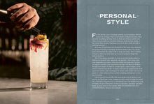 Load image into Gallery viewer, A skilled hand pours a liquid into a tall, frosty cocktail glass garnished with lemon and cherry, exemplifying the artistry of mixology according to &quot;The Bartender&#39;s Manifesto.&quot; The blurred shelves of glassware in the background highlight the craft of bartending. Text on the right reads &quot;Personal Style,&quot; focusing on whisky cocktails and experiences. Page 243 is noted below.
