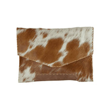 Load image into Gallery viewer, The Diana Clutch - Cowhide Hairon Leather showcases a rectangular envelope-style crafted from luxurious cowhide hairon leather with a flap closure. Highlighted by white and brown splotches, its edges are enhanced with whipstitch detailing, providing a soft texture and displaying an asymmetrical triangular flap when closed.
