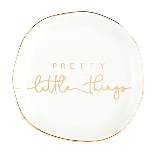 The Trinket Tray - Little Things is a charming, small white ceramic dish with a slightly irregular round shape. It features 