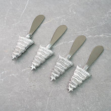 Load image into Gallery viewer, A set of four Christmas Tree Spreaders is artfully arranged diagonally on a textured gray surface, featuring handles shaped like festive trees with a star on top and horizontal lines creating a layered design. Ideal for any holiday gathering.
