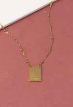 Load image into Gallery viewer, The It Is Well Necklace, crafted with 14K gold plating, showcases a rectangular pendant set against a pink backdrop with the inscription &quot;IT IS WELL WITH MY SOUL.&quot; Its delicate chain comprises small links that enhance its minimalist elegance, capturing faith and serenity in its graceful design.
