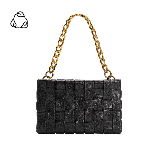 The Mimie Recycled Vegan Crossbody Bag is a chic handbag with a woven design featuring black textured squares made from recycled vegan leather. It boasts a gold chain strap, compact rectangular shape, and has a subtle black recycling symbol on white in the top left, perfect for any occasion.