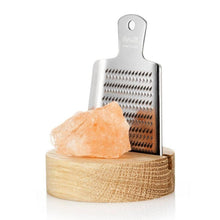 Load image into Gallery viewer, The RIVSALT™ Original Himalayan Rock Salt Gift Set features a stainless steel grater mounted vertically on a natural oak stand. In front of the grater, a large chunk of pink Himalayan salt is elegantly displayed. The grater bears the labels &quot;rivsalt&quot; and &quot;Made in Sweden,&quot; presenting a clean, minimalistic aesthetic perfect for culinary use.
