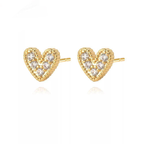 The Nia Pave Heart Studs showcase a heart shape with a gold rope texture and small, clear gemstones set symmetrically. An 18k gold-plated finish enhances their sparkle. These elegant earrings are displayed side by side on a white background.