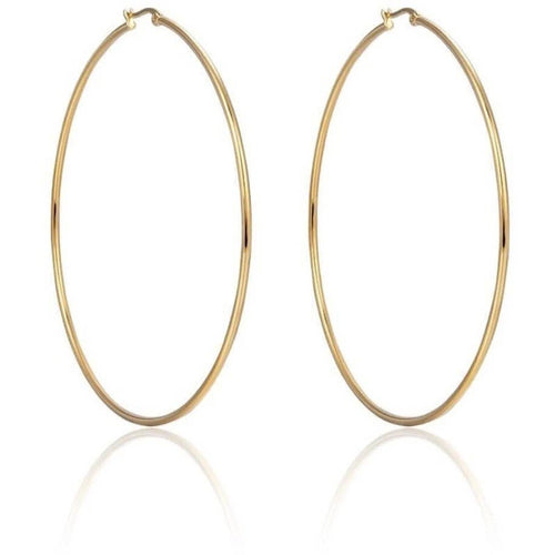 Introducing the Oval Hula Hoops: large, gold-plated hoop earrings featuring a smooth, polished finish. These tarnish-resistant earrings are symmetrically designed with a simple clasp closure at the top. Positioned vertically against a white background, their faint shadow offers an elegant reflection.