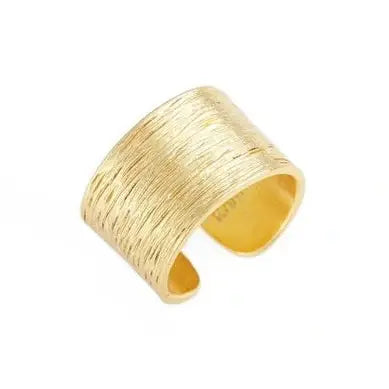 The Brushed Ring is a wide, gold band with an open-ended design, featuring fine, parallel lines that give it a textured and brushed appearance. Its interior is smooth and polished. This adjustable ring is plated with 24 kt gold, offering a modern and minimalist style.